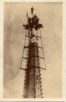 A postcard of men working on Wakefield Cathedral spire